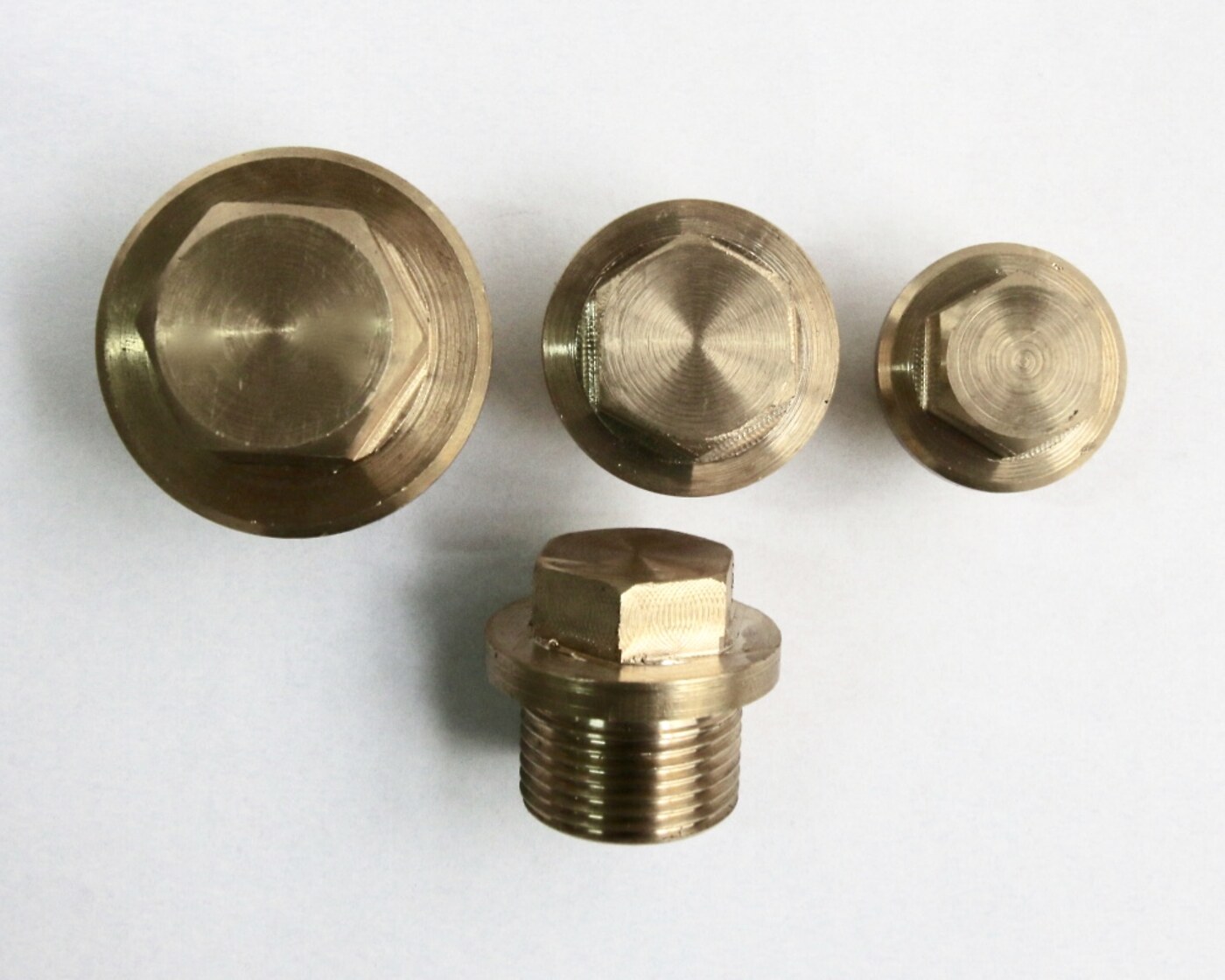 Machined bronze plugs and threaded caps