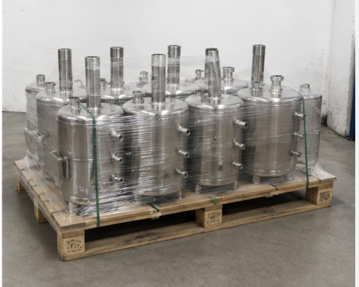 Series of stainless-steel process vessels on a pallet